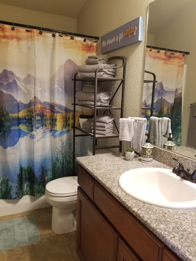 Guest bathroom with tub and shower combo and fresh towels