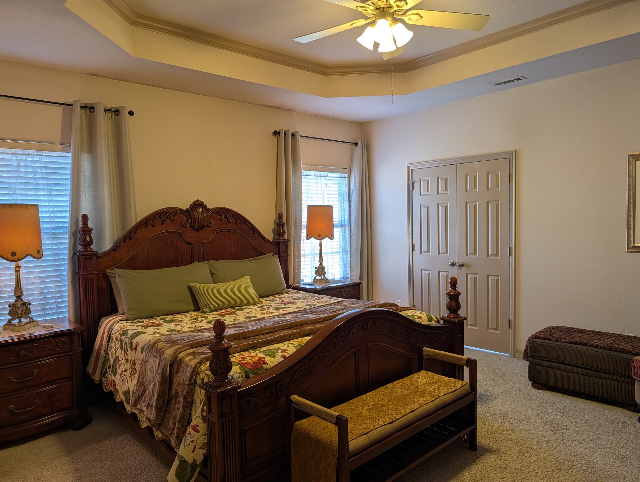 Master king bedroom with tray ceiling and wood bedroom set