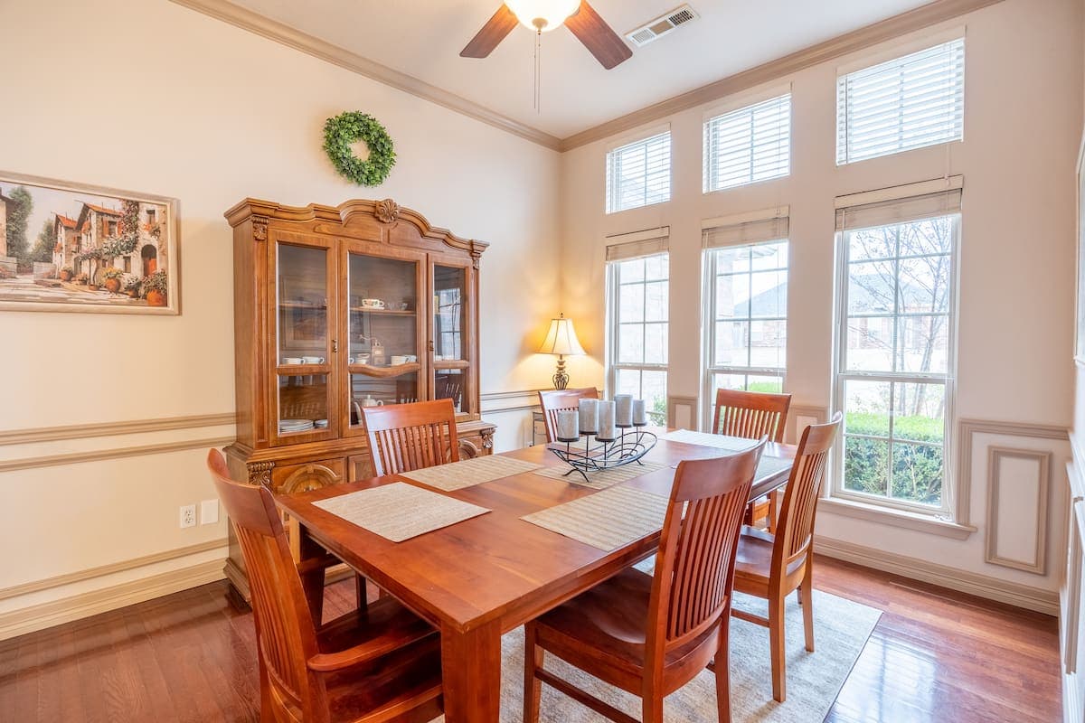 Formal dining room seating up to eight with hutch and natural light