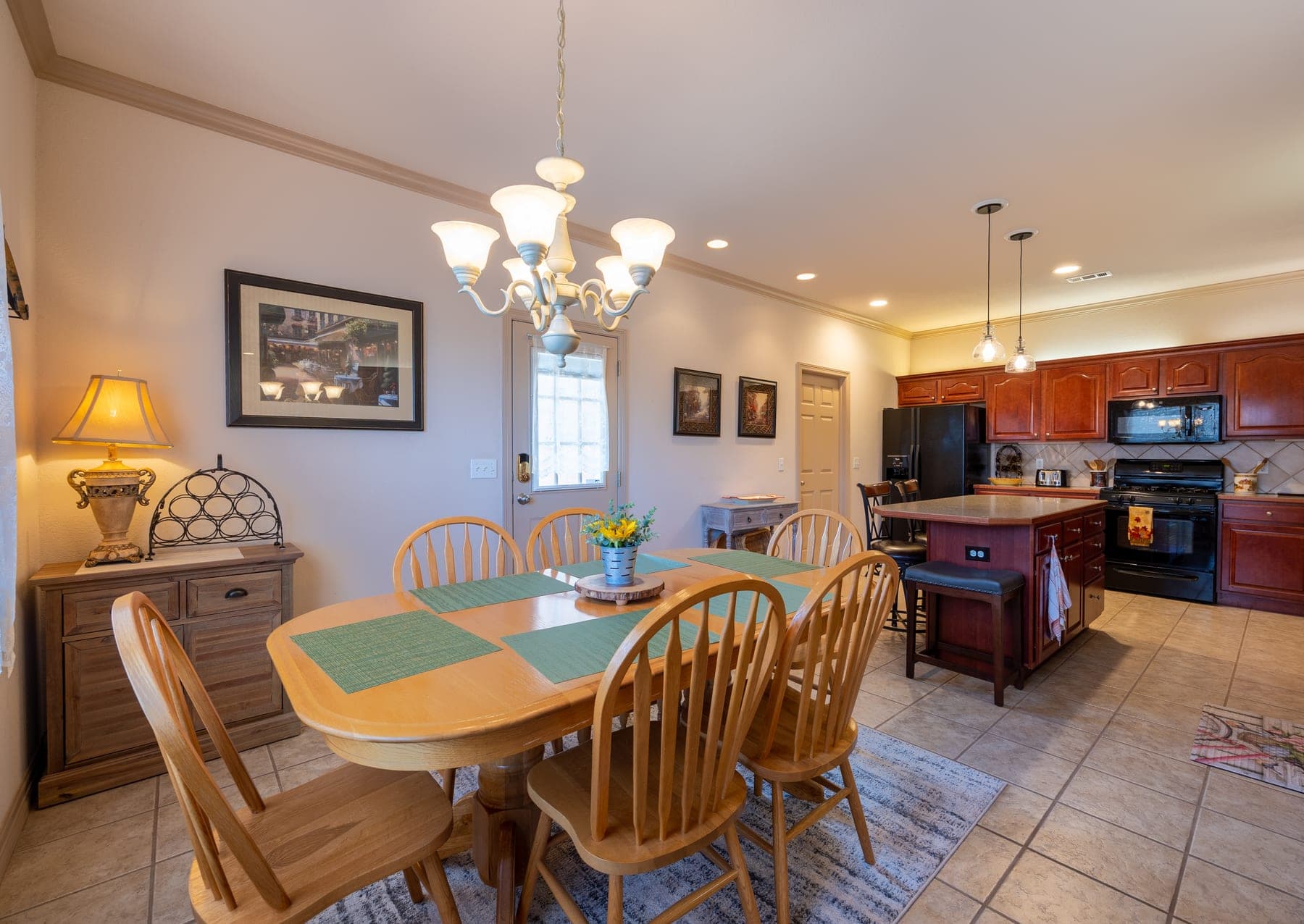 Kitchen breakfast table with chandelier, open to the kitchen